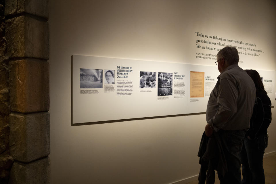 Visitors read information about Rose Valland and others at the Monuments Men and Women exhibition at The National WWII Museum in New Orleans, Thursday, Feb. 15, 2024. (AP Photo/Christiana Botic)