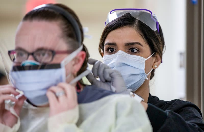 Nurse dons personal protective equipment at Madigan Army Medical Center's enhanced coronavirus disease screening site