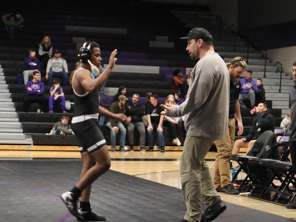 Liberty's Anyhlan Peoples approaching his head coach Frederick Lima following his victory over Cedar Falls' Eric Malaise.