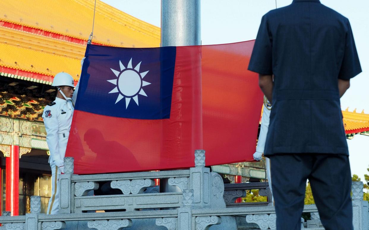 Soldiers perform a flag-raising ceremony in Taiwan - REX