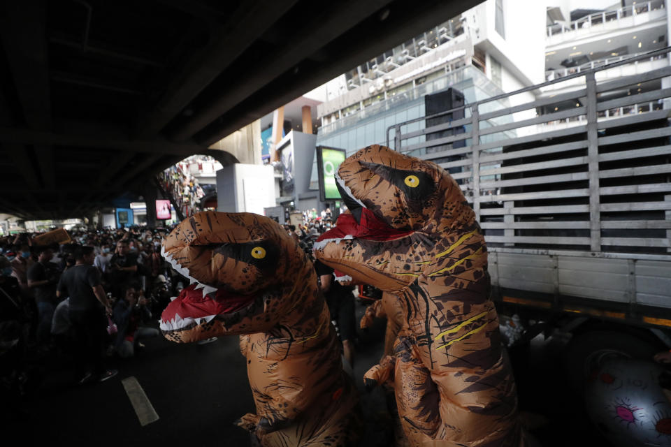 Dinosaur mascots are seen at a student rally in Bangkok, Saturday, Nov. 21, 2020. Organized by a group that mockingly calls themselves "Bad Students," the rally calls for educational reforms and also supports the broader pro-democracy movement's demands for constitutional change. (AP Photo/Sakchai Lalit)