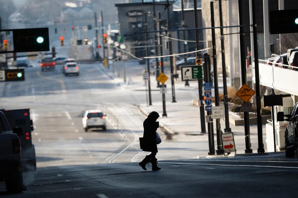 A pedestrian crosses a street in the frigid cold, Friday, January 5, 2018, in Cincinnati.