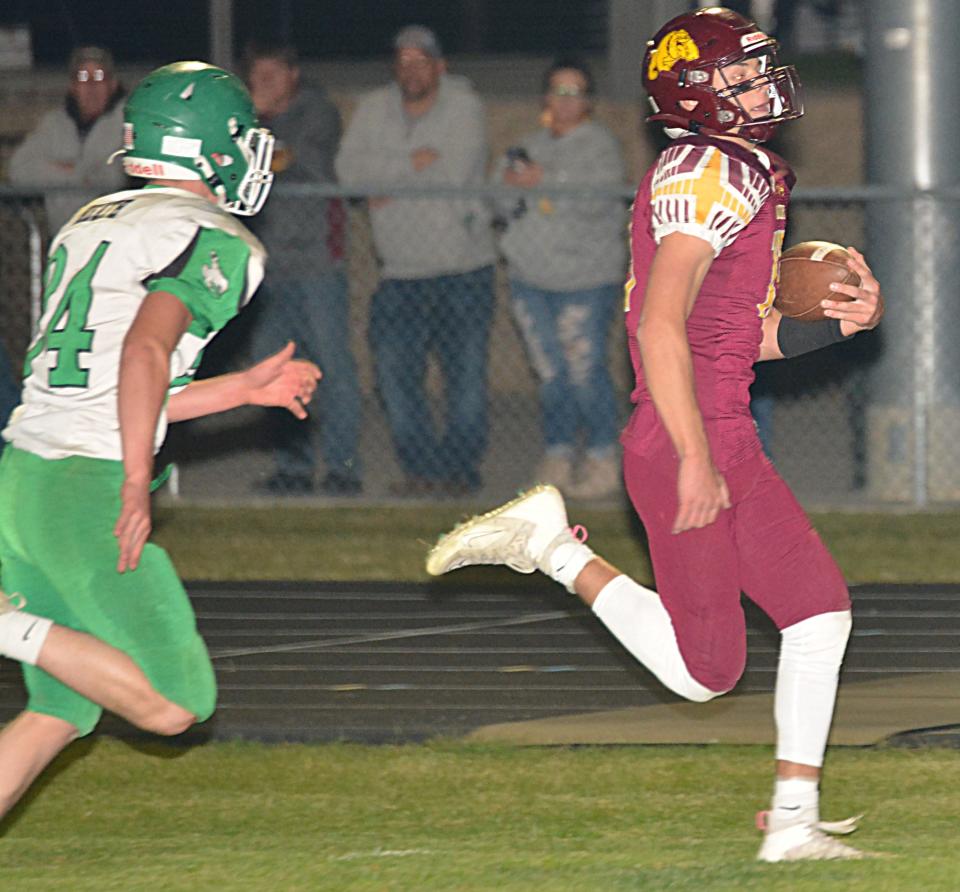 De Smet quarterback Britt Carlson dashes to the end zone against Colome's Seth Heath during their first-round state Class 9B high school football playoff game on Thursday, Oct. 19, 2023 at De Smet.