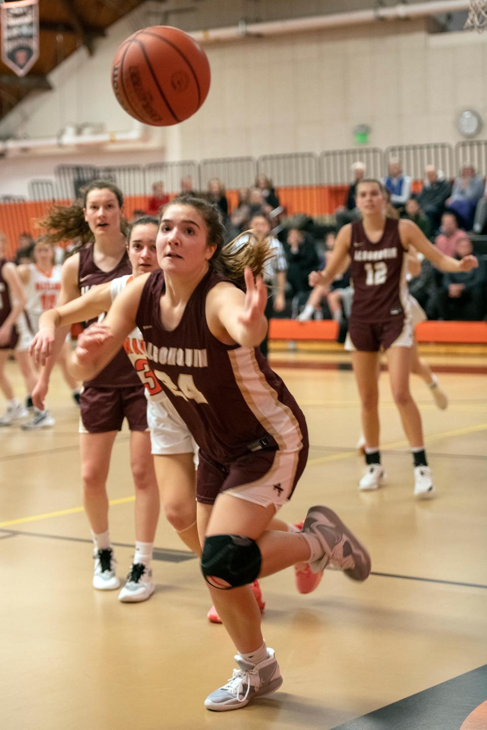 Algonquin sophomore Brooke Adams chases a loose ball during the game at Wayland High, Dec. 22, 2022. The Warriors beat the Titans, 45-37.