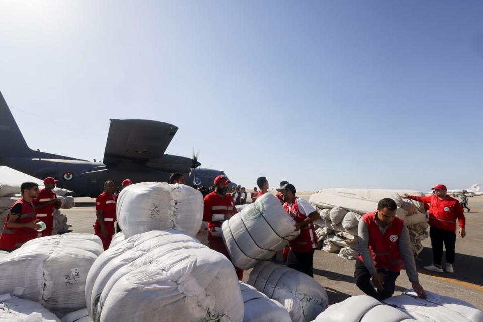 Egyptian Red Crescent members coordinate aid for Gaza at Al Arish Airport, Egypt.