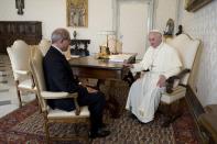 Pope Francis (R) talks with Ahmet Uzumcu, director-general of the Organisation for the Prohibition of Chemical Weapons (OPCW), during a private visit at the Vatican September 27, 2013. (REUTERS/Osservatore Romano)