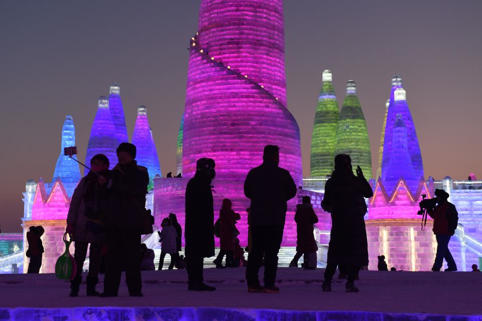 <p>People visit the Harbin Ice and Snow World, part of the annual Harbin Ice and Snow Sculpture Festival in China’s northeast Heilongjiang province. (Photo: Greg Baker/AFP/Getty Images) </p>