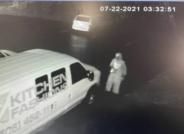 At around 3 a.m. Thursday morning, a man is spotted on security footage smashing the windows of three vans.  (Submitted by Home Fashions  - image credit)