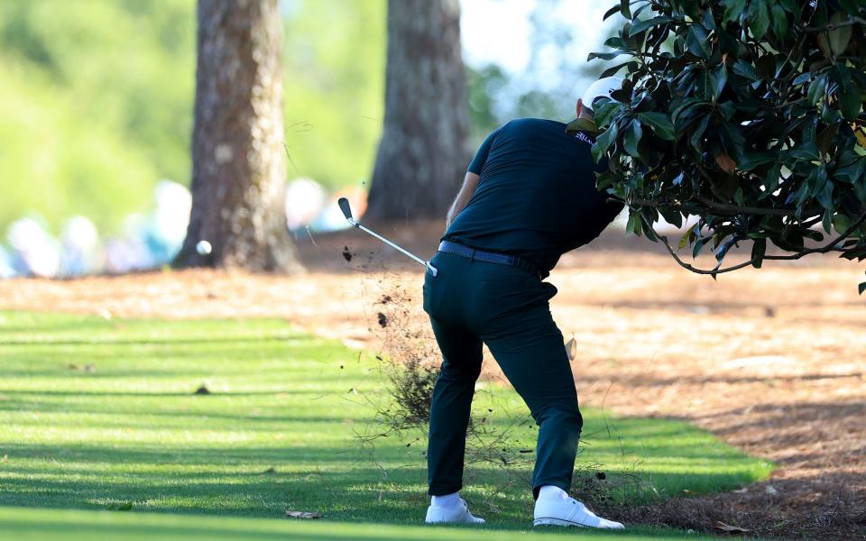 Dustin Johnson of The United States plays his second shot on the 18th hole