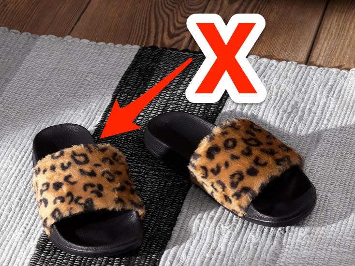 red x and arrow pointing at faux fur leopard print slides on a rug