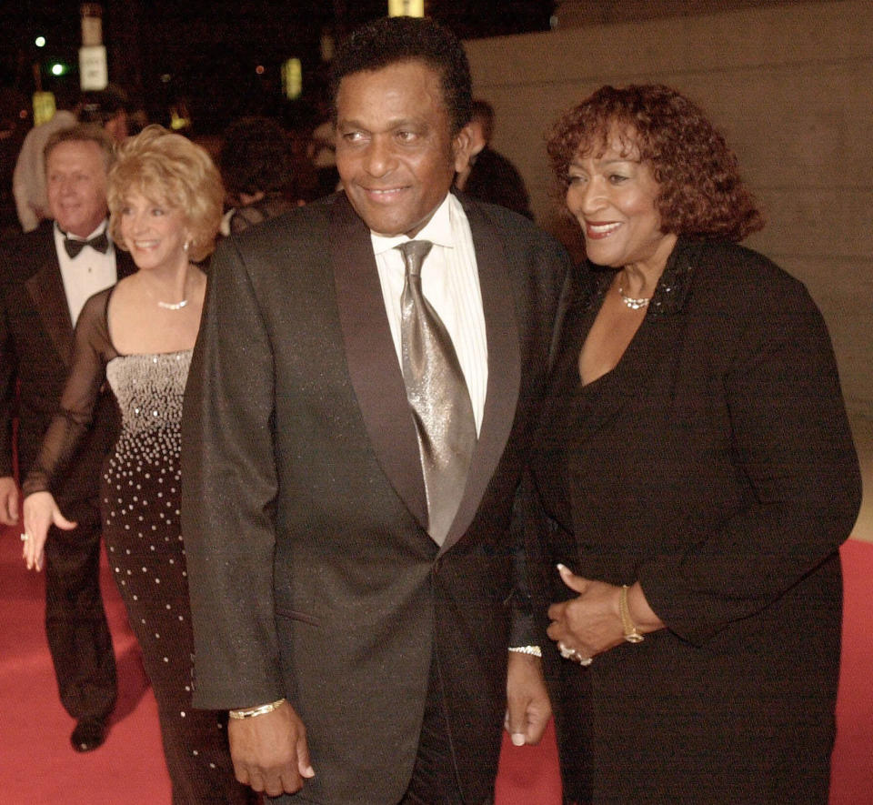 CORRECTS FIRST NAME TO CHARLEY, INSTEAD OF CHARLIE FILE - In this Oct. 26, 2000, file photo, Country music legend Charley Pride with his wife Rozene arrive at the Gaylord Entertainment Center to celebrate, Garth Brooks' selling 100 million albums, during a private party in his honor in Nashville, Tenn. Pride, the son of sharecroppers in Mississippi and became one of country music’s biggest stars and the first Black member of the Country Music Hall of Fame, has died at age 86. Pride died Saturday, Dec. 12, 2020, in Dallas of complications from Covid-19, according to Jeremy Westby of the public relations firm 2911 Media. (AP Photo/John Russell, File)
