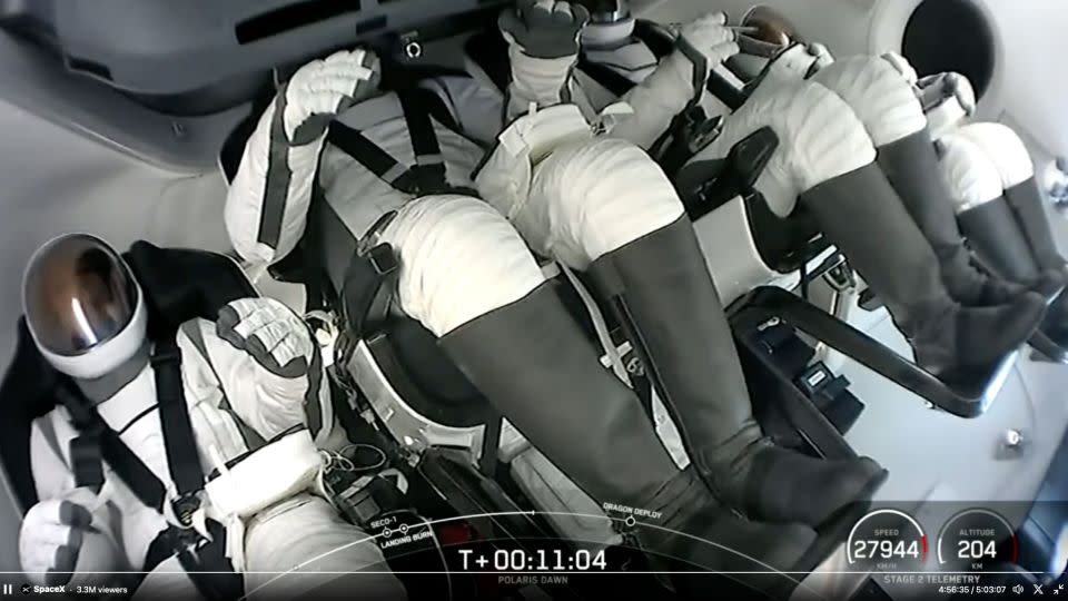 In this screenshot from video, the Polaris Dawn crew sit in the Dragon capsule shortly after launching towards space on Tuesday. - SpaceX