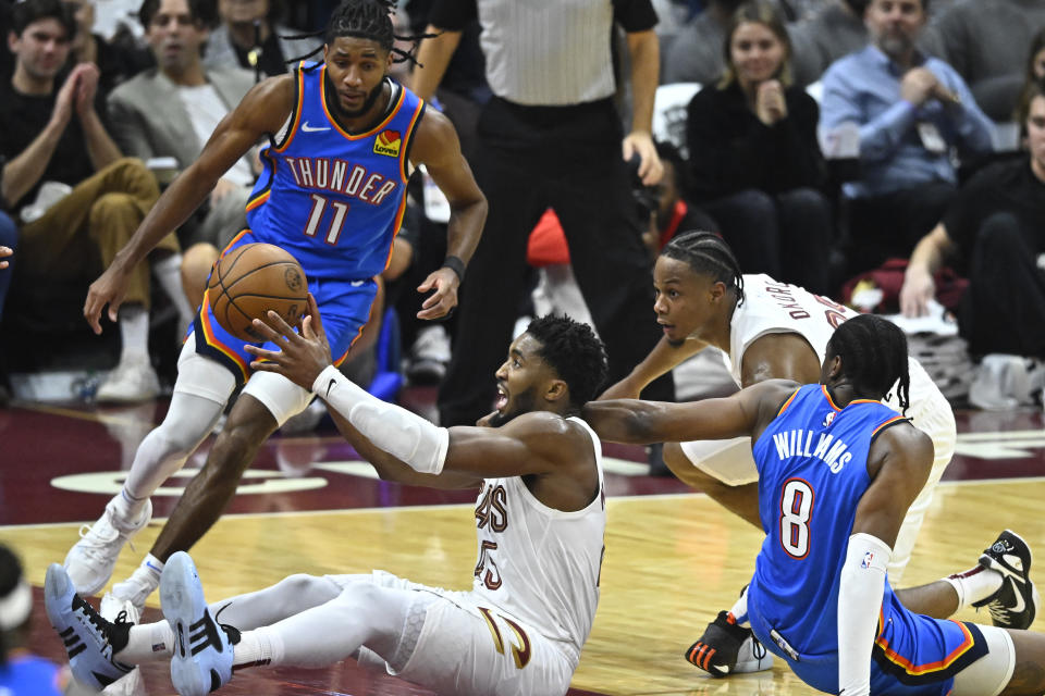 Oct 27, 2023; Cleveland, Ohio, USA; Cleveland Cavaliers guard Donovan Mitchell (45) throws a pass after recovering the ball in the second quarter against the Oklahoma City Thunder at Rocket Mortgage FieldHouse. Mandatory Credit: David Richard-USA TODAY Sports