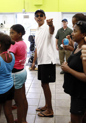 U.S. President Barack Obama points while waiting in line at a shave ice shop in Kailua, Hawaii January 3, 2011. REUTERS/Kevin Lamarque