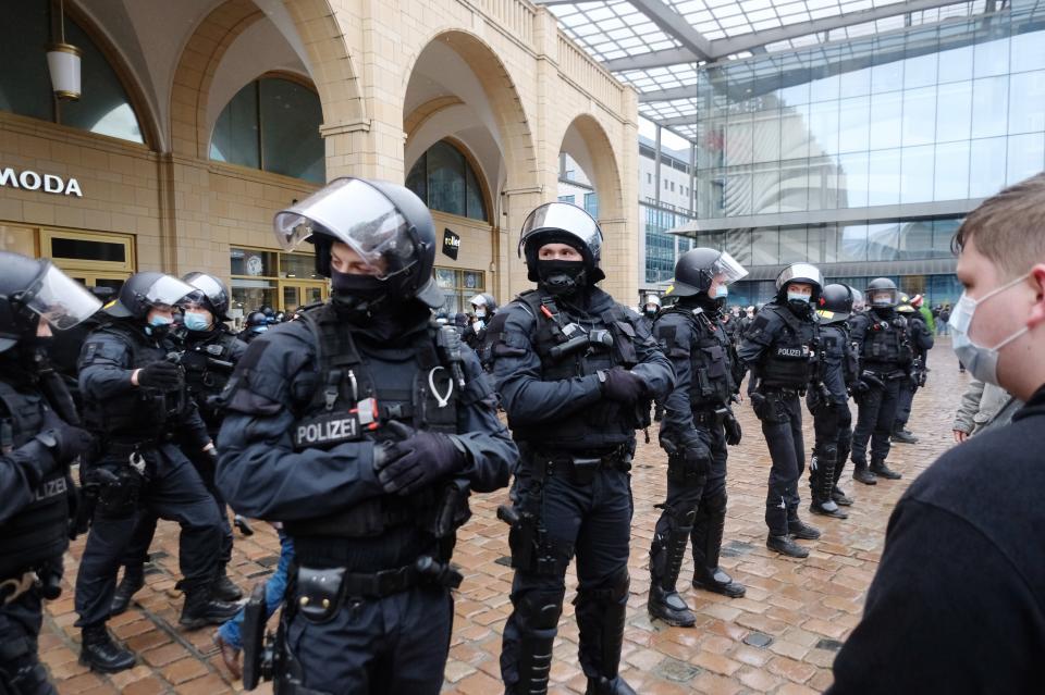 Police officers block the Neumarkt in Chemnitz, Germany, Saturday, March 27, 2021. There participants of a rally wanted to demonstrate against the Corona policy. The meetings were forbidden. (Sebastian Willnow/dpa via AP)