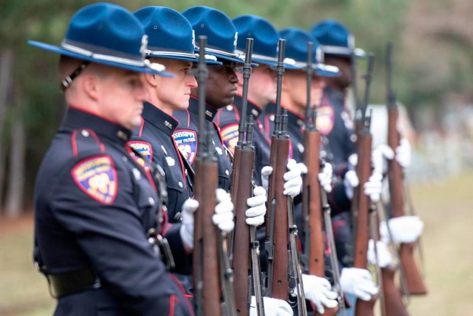 Mississippi Highway Patrol officers prepare to fire ceremonial blanks during the funeral of Bay St. Louis police officers Sgt. Steven Robin and Branden Estorffe at Gardens of Memory cemetery in Bay St. Louis on Wednesday, Dec. 21, 2022. Robin and Estorffe were killed responding to a call at a Motel 6 on Dec. 14.