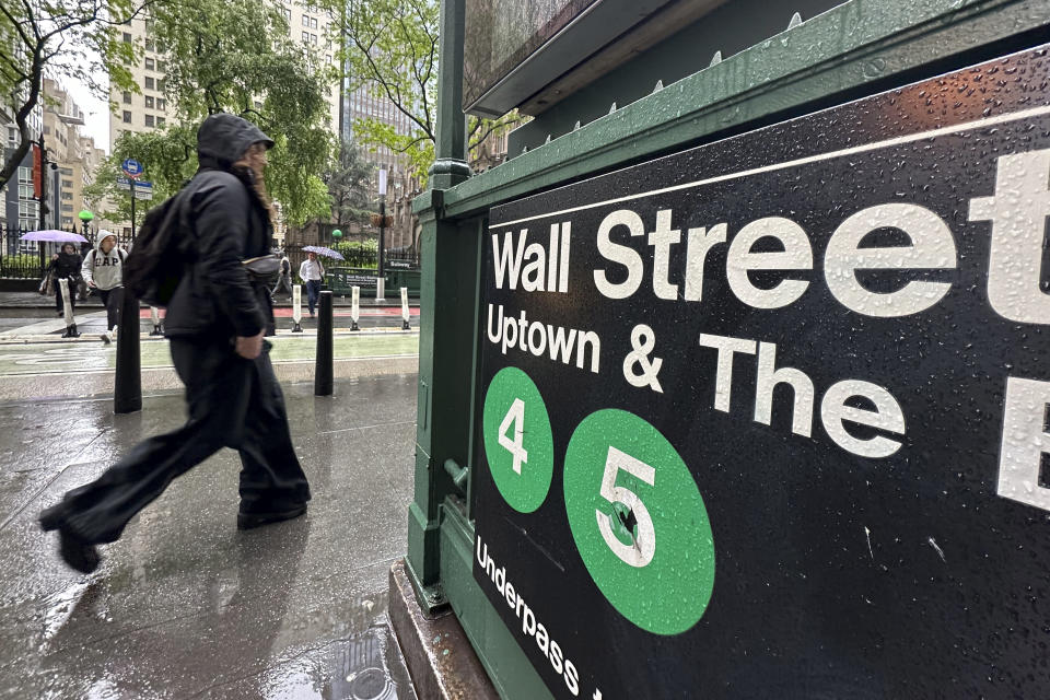 A person passes an entrance to the Wall Street subway station in New York on Wednesday, May 15, 2024. Trading on Wall Street is muted early ahead of the U.S. government's latest reports on inflation and retail sales. (AP Photo/Peter Morgan)