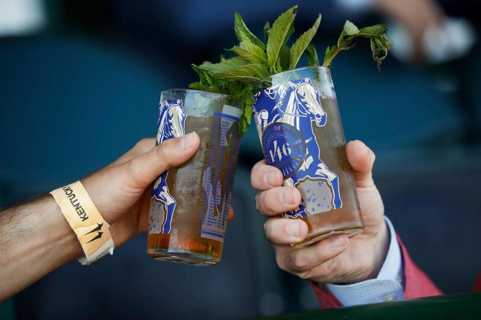 Two mint juleps are clinked in the stands before the 146th running of the Kentucky Derby at Churchill Downs in Louisville, Ky., Saturday, Sept. 5, 2020. Alex Slitz/aslitz@herald-leader.com