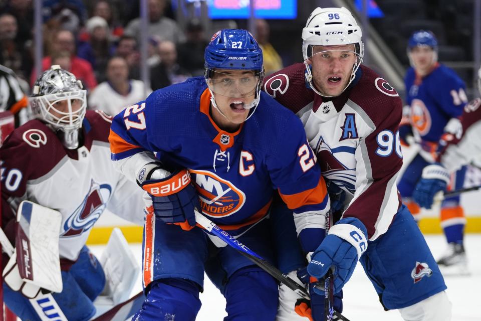 Colorado Avalanche's Mikko Rantanen (96) works for position against New York Islanders' Anders Lee (27) during the second period of an NHL hockey game Tuesday, Oct. 24, 2023, in Elmont, N.Y. (AP Photo/Frank Franklin II)