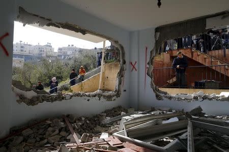 Relatives and onlookers look at the demolished house of Palestinian Bahaa Mohammed Halil Allyan in the Arab east Jerusalem neighbourhood of Jabel Mukaber January 4, 2016. REUTERS/Ammar Awad