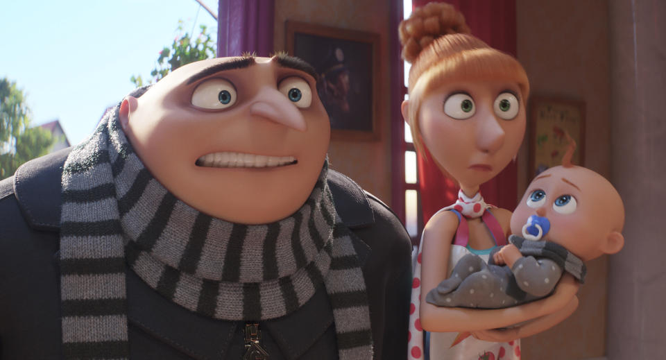 This image release by Illumination & Universal Pictures shows Gru, voiced by Steve Carell, left, and Lucy, voiced by Kristen Wiig, holding Gru Jr. in a scene from "Despicable Me 4," (Illumination & Universal Pictures via AP)