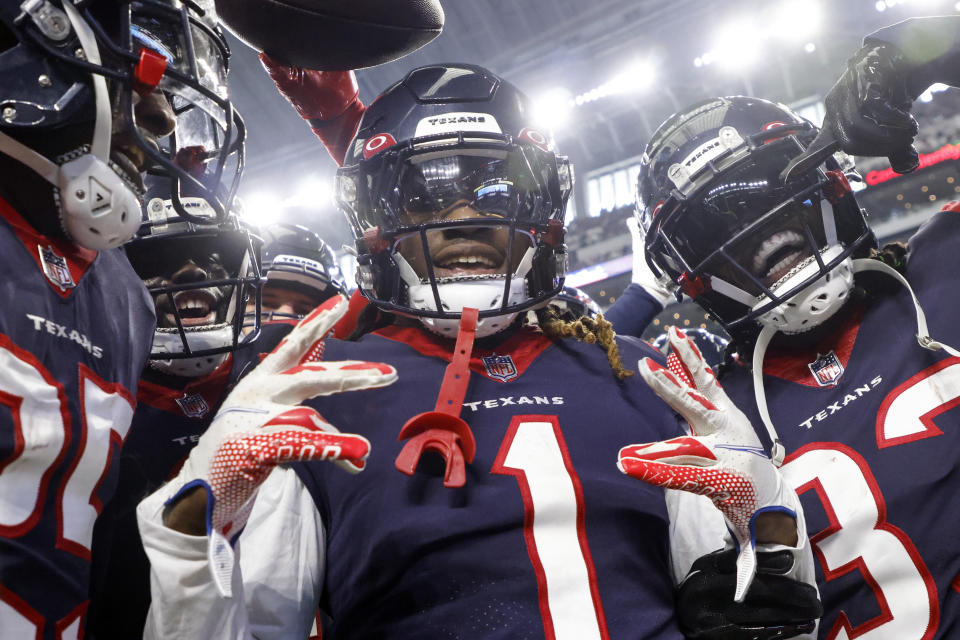 Houston Texans cornerback Tremon Smith (1) celebrates with Dare Ogunbowale (33) after intercepting a pass in the first half of an NFL football game against the Dallas Cowboys, Sunday, Dec. 11, 2022, in Arlington, Texas. (AP Photo/Michael Ainsworth)