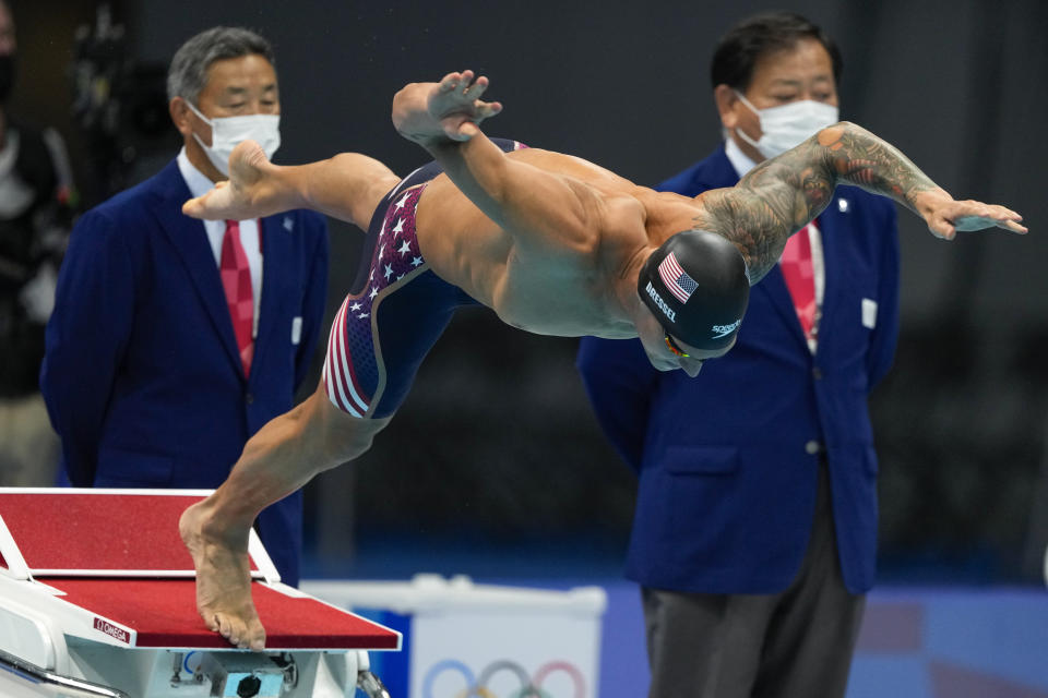 Caeleb Dressel, of United States, starts the men's 100-meter butterfly final at the 2020 Summer Olympics, Saturday, July 31, 2021, in Tokyo, Japan. (AP Photo/Jae C. Hong)