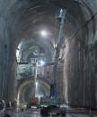 A worker has the cherry picker nearly at its maximum reach, which shows just how large certain sections of the project have become.