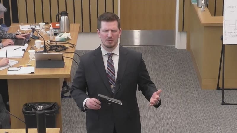 Multnomah County Deputy DA Shawn Overstreet holds one of Nancy Brophy’s guns during closing arguments in her murder trial, May 23, 2022 (KOIN)