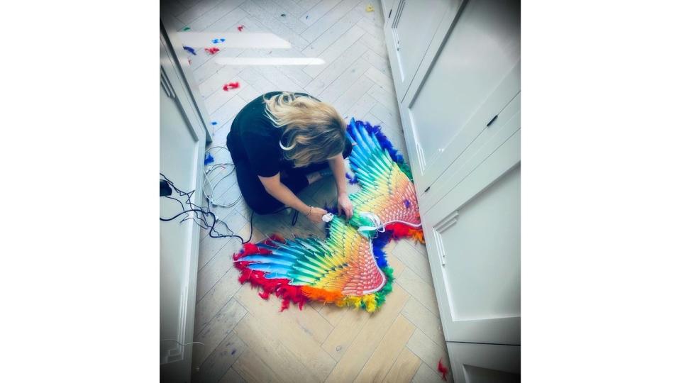 Georgia glues rainbows wings together on kitchen floor 