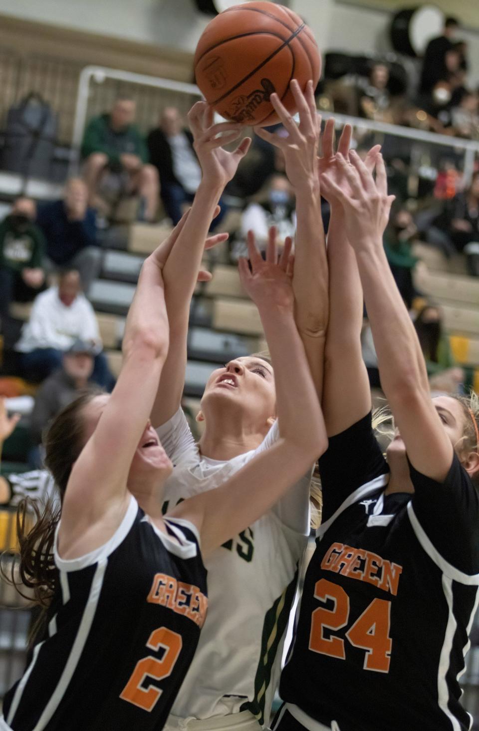 GlenOak’s Kiley Dyrlund battles for a rebound with Green’s Mallory Oddo (2) and Jenna Slates during a game on Jan. 5.