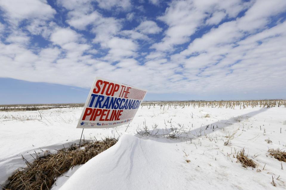 FILE - This March 11, 2013 file photo shows a sign reading "Stop the Transcanada Pipeline" in a field near Bradshaw, Neb. The US is extending indefinitely the amount of time federal agencies have to review the Keystone XL pipeline, the State Department said Friday, likely punting the decision over the controversial oil pipeline until after the midterm elections. The State Department didn’t say how much longer it will grant agencies to weigh in, but cited a recent decision by a Nebraska judge that overturned a state law that allowed the pipeline's path through the state, prompting uncertainty and an ongoing legal battle. Nebraska’s Supreme Court isn’t expected to rule for another several months and there could be more legal maneuvering after that, potentially freeing President Barack Obama to avoid making a final call on the pipeline until after the election in November. (AP Photo/Nati Harnik, File)