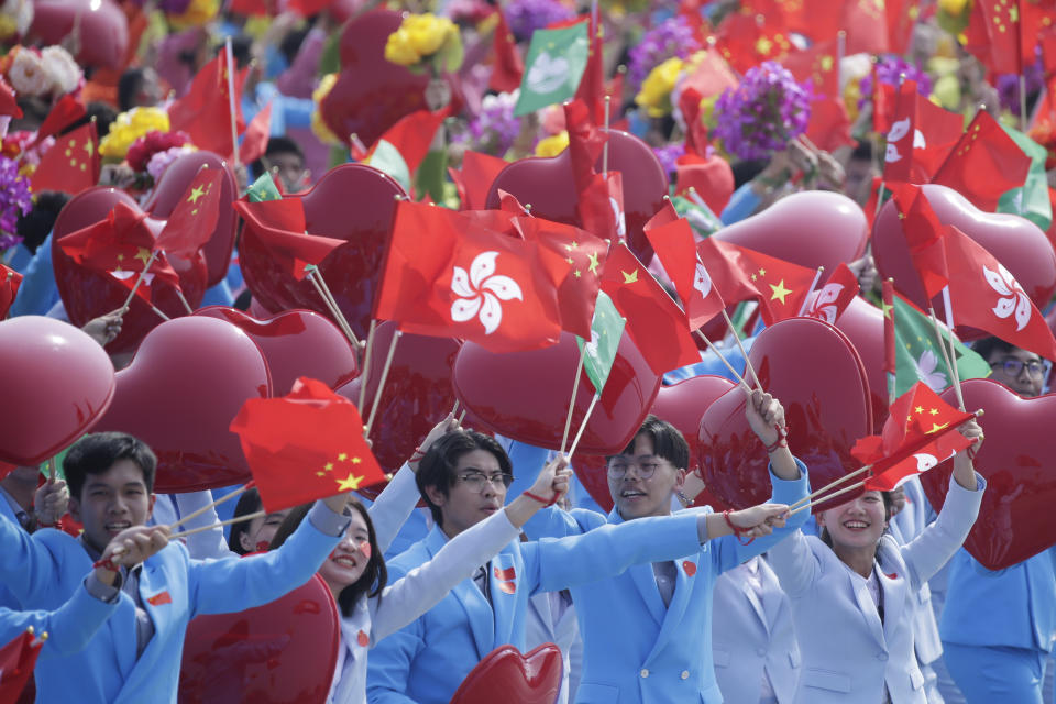 Performers wave Chinese, Hong Kong and Macau flags during the parade marking the 70th founding anniversary of People's Republic of China, on its National Day in Beijing, China October 1, 2019. (Photo: Jason Lee/Reuters)