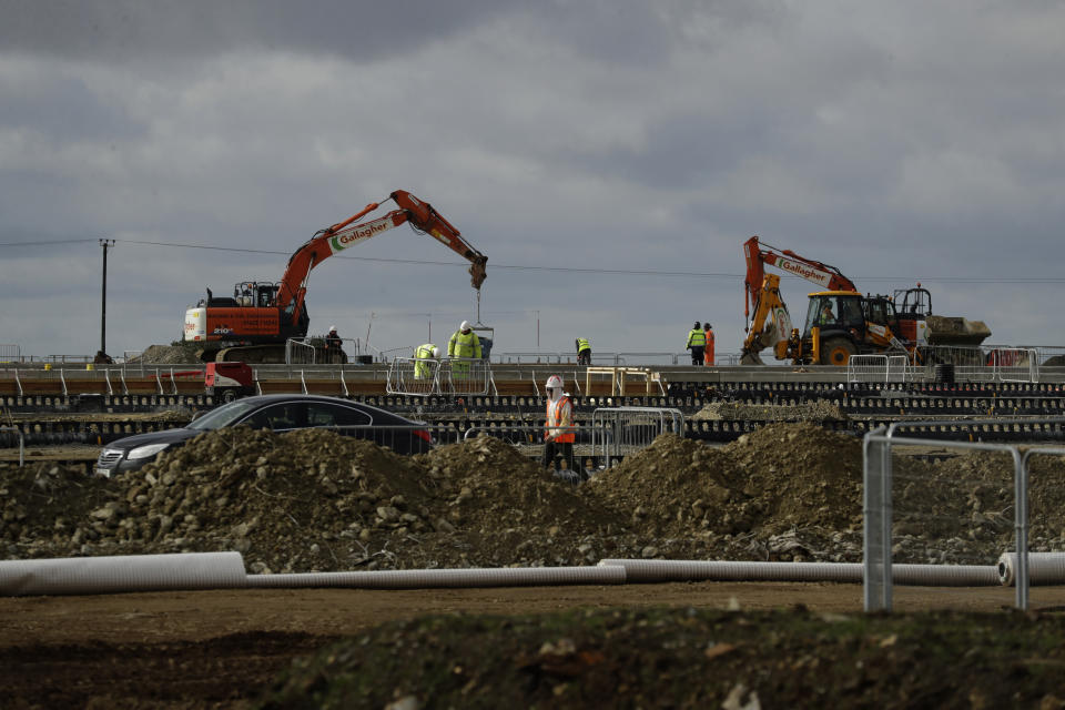 Construction takes place on a post-Brexit customs clearance border post facility on land that was previously a field between the villages of Mersham and Sevington in the county of Kent, south east England, Tuesday, Oct. 6, 2020. (AP Photo/Matt Dunham)