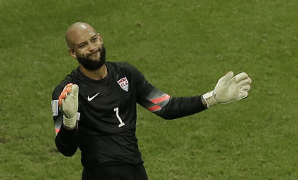 Tim Howard gestures to his teammates after making a save during the U.S. team's loss to Belgium. (AP)