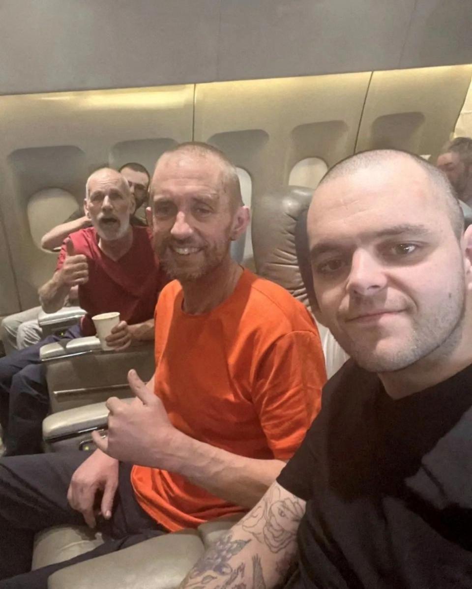 John Harding, Shaun Pinner and Aiden Aslin pictured in plane after their release (Instagram/cossackgundi via REUTERS)