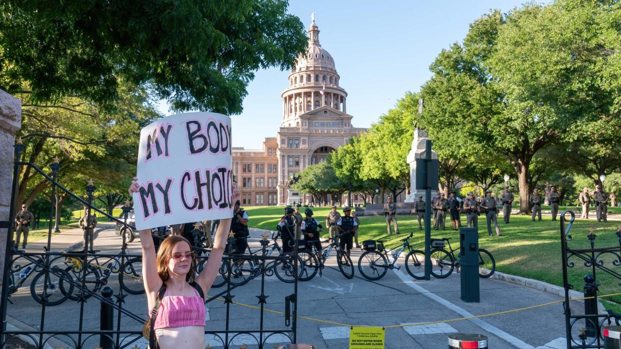  A woman protests at the Texas capitol. 