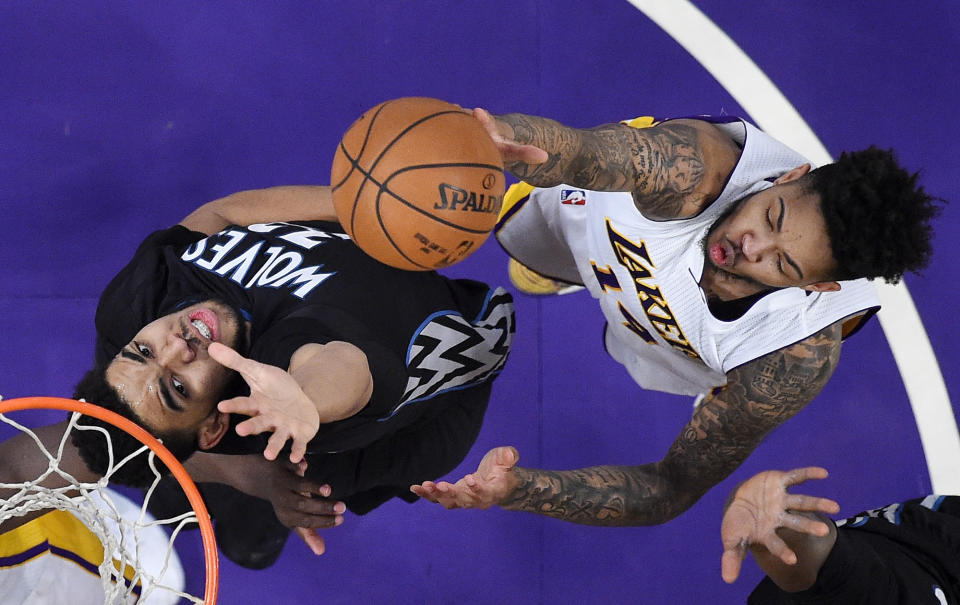 Los Angeles Lakers forward Brandon Ingram, right, shoots as Minnesota Timberwolves center Karl-Anthony Towns defends during the first half of an NBA basketball game, Sunday, April 9, 2017, in Los Angeles. (AP Photo/Mark J. Terrill)