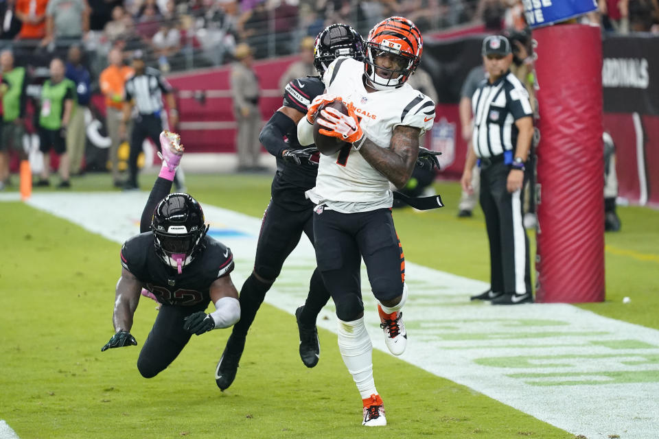 Cincinnati Bengals wide receiver Ja'Marr Chase, right, pulls in a touchdown pass as Arizona Cardinals cornerback Marco Wilson defends during the second half of an NFL football game, Sunday, Oct. 8, 2023, in Glendale, Ariz. (AP Photo/Ross D. Franklin)