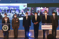 Thailand Prime Minister Prayuth Chan-ocha, center left, and James Teague, second right, president of AstraZeneca's in Thailand attend a signing ceremony at Government House in Bangkok, Thailand Friday, Nov. 27, 2020. Thailand on Friday signed a deal to procure 26 million doses of the trial coronavirus vaccine developed by pharmaceutical firm AstraZeneca in collaboration with Oxford University. (Chalinee Thirasupa/Pool Photo via AP)