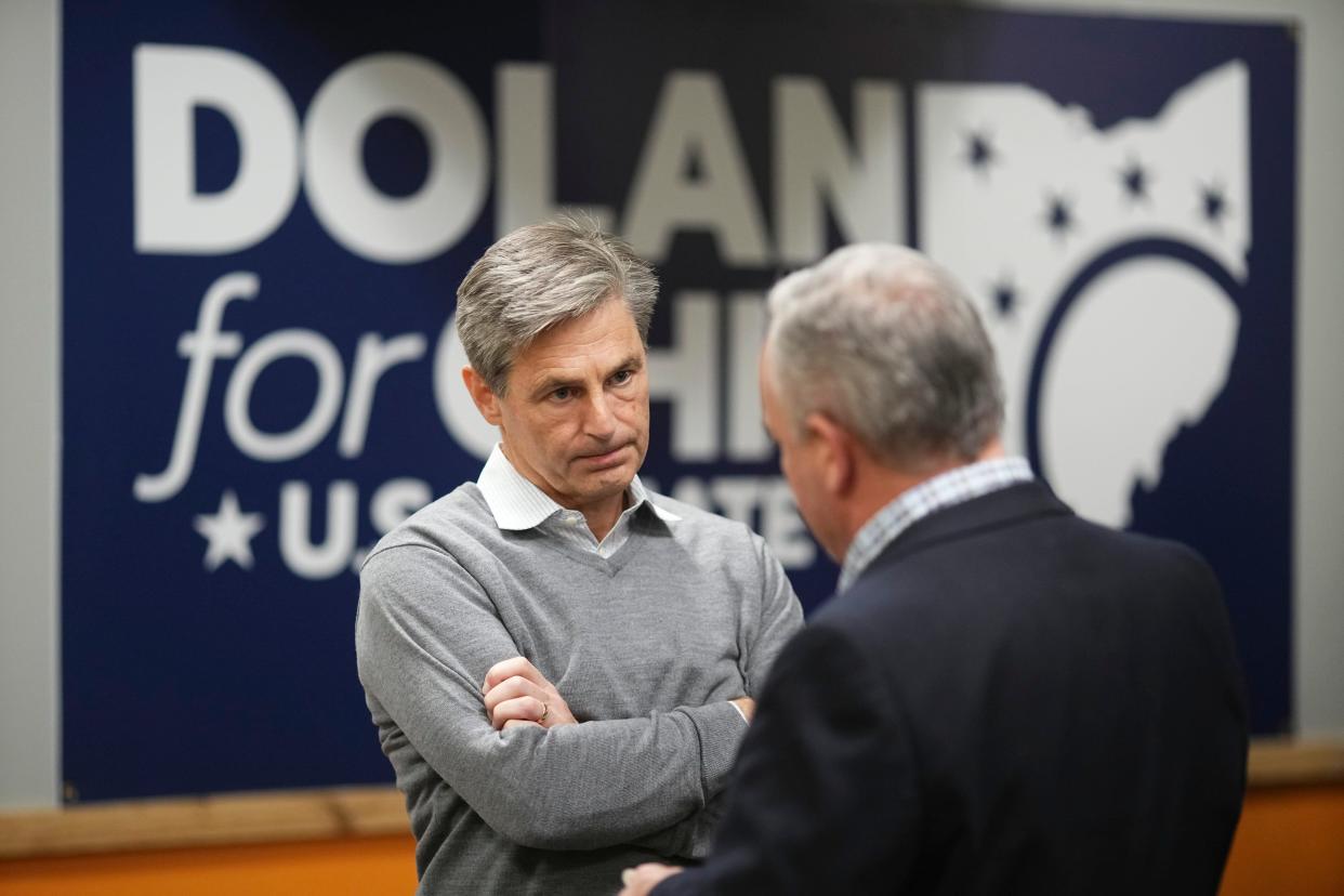 U.S. Senate candidate Matt Dolan listens to Brian Carnahan during a campaign event at Ten Pin Alley in Hilliard on Jan. 18.