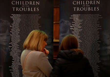 People look at a list of names of children who died during the 'troubles' at the launch of the Children of the Troubles book in Londonderry, Northern Ireland