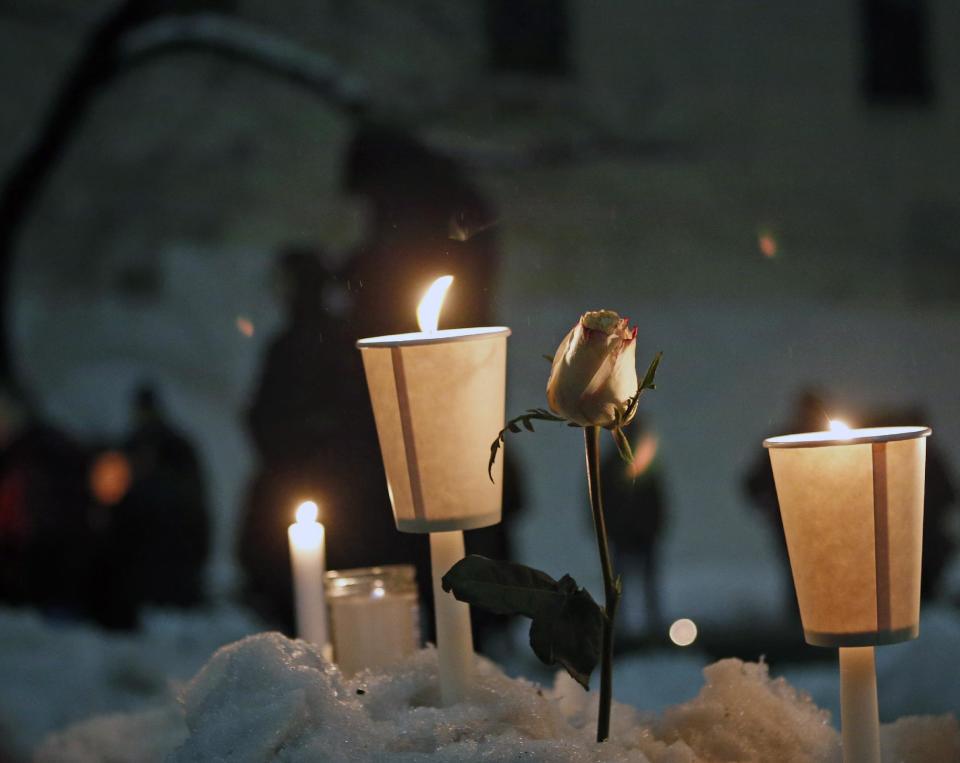 Candles burn alongside a rose left in a snowbank following a candlelight vigil sponsored by the Labyrinth Theater Company in the courtyard of the Bank Street theater for actor Philip Seymour Hoffman, a company member and former Labyrinth artistic director, Wednesday, Feb. 5, 2014, in New York. Hoffman died on Sunday of a suspected drug overdose. (AP Photo/Kathy Willens)