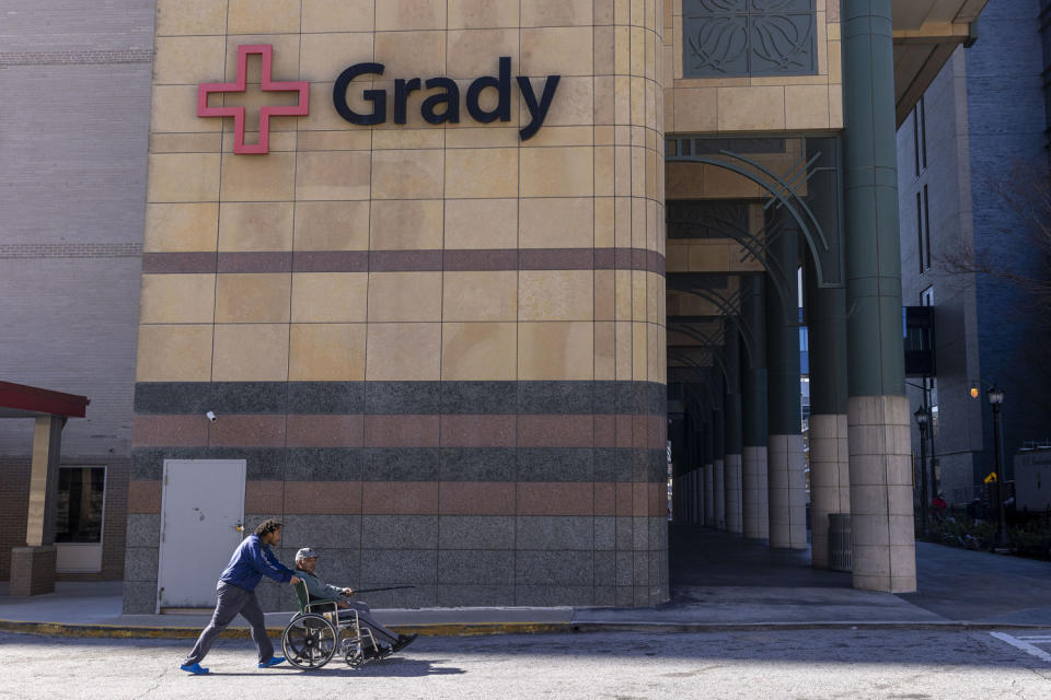 A pedestrian is wheeled away from the emergency entrance at Grady Memorial Hospital (Alyssa Pointer for NBC News)