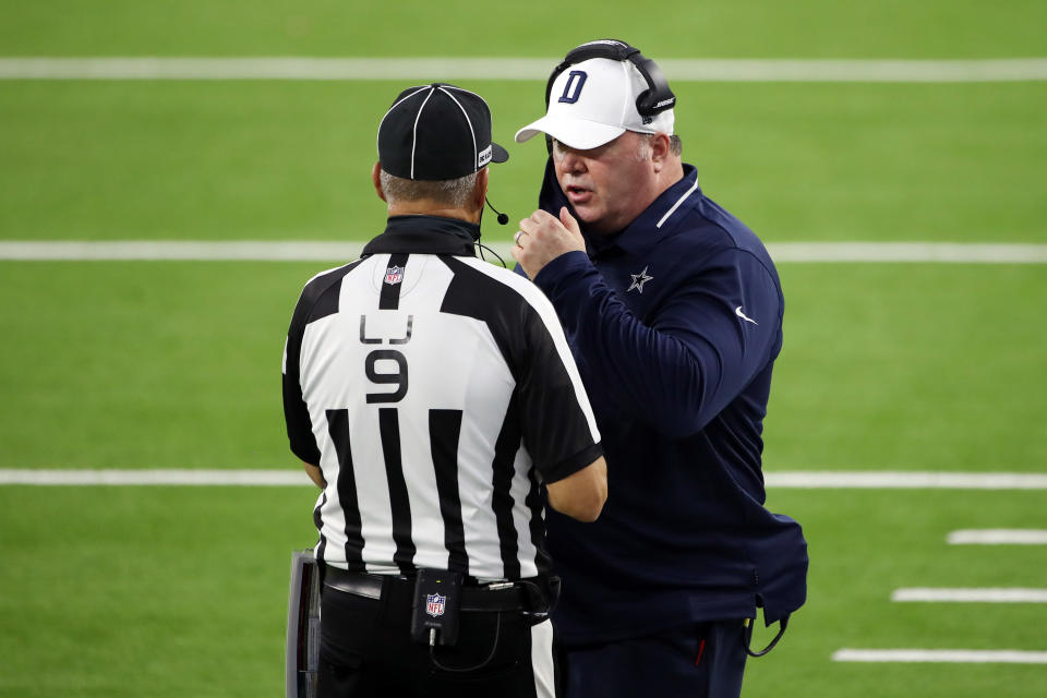 Cowboys coach Mike McCarthy talks with line judge Mark Perlman during Sunday night's loss to the Rams. (Photo by Katelyn Mulcahy/Getty Images)