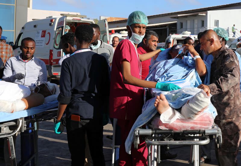 Paramedics assist Turkish workers injured in an explosion in Afgoye town, before they board a Turkish military cargo plane at the Aden Abdulle International Airport in Mogadishu