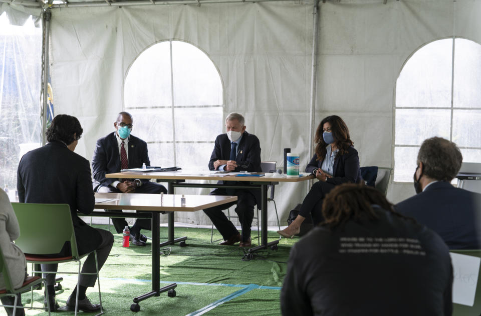 Los Angeles City Council member Kevin de Leon, far left, addresses U.S. District Judge Andre Birotte, second from left, U.S. District Court Judge David Carter, middle, and special master Michele Martinez, right, at a court hearing inside a tent at Downtown Women's Center in Los Angeles, Thursday, Feb. 4, 2021. Carter said the rainstorm the week before created "extraordinarily harsh" conditions for homeless residents of Los Angeles, prompting him to order city officials to meet with him at a Skid Row shelter to discuss how to address the worsening crisis of people living on the streets. Carter noted that 1,383 homeless people died in the city and county of Los Angeles last year, a 32% increase from 2019. (AP Photo/Damian Dovarganes)