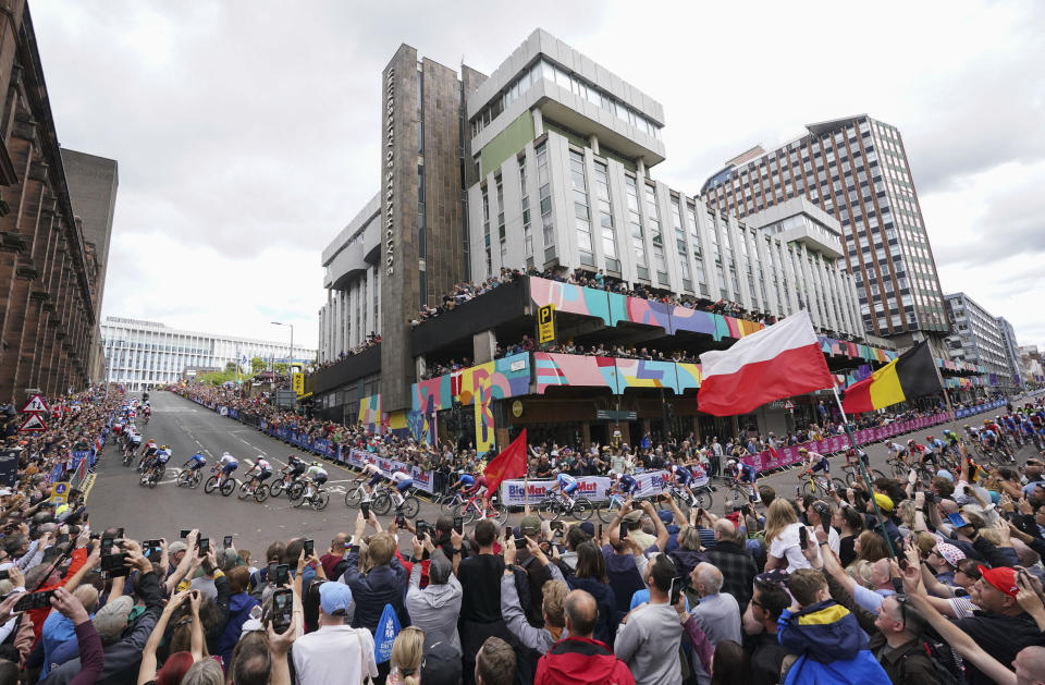 The peloton makes its way up Montrose Street in Glasgow during the Men's Elite Road Race on day four of the 2023 UCI Cycling World Championships in Glasgow, Scotland, Sunday Aug. 6, 2023. (Tim Goode/PA via AP)