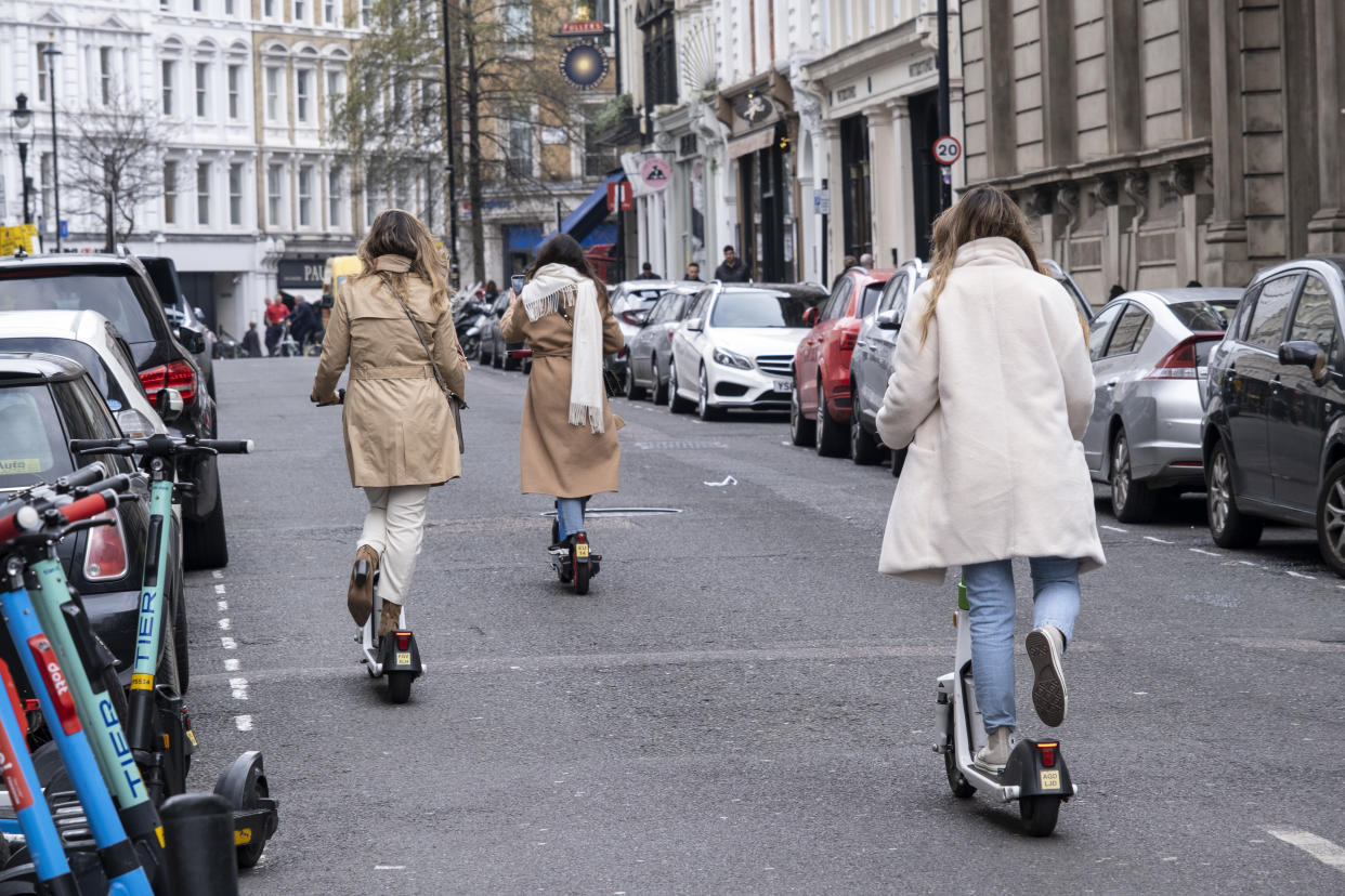 Young women riding eScooters on 3rd March 2022 in London, United Kingdom. A scooter-sharing system is a shared transport service in which electric motorized scooters, also referred to as e-scooters, are made available to use for short-term rentals. E-scooters are typically dockless, meaning that they do not have a fixed home location and are dropped off and picked up from certain locations in the service area. (photo by Mike Kemp/In Pictures via Getty Images)