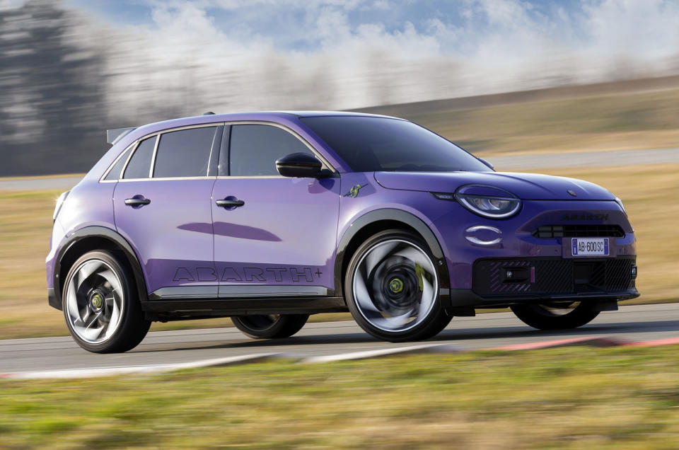 Purple Abarth 600e drifting   front three quarters